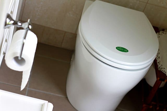 Example of waterless composting toilet installed in small bathroom