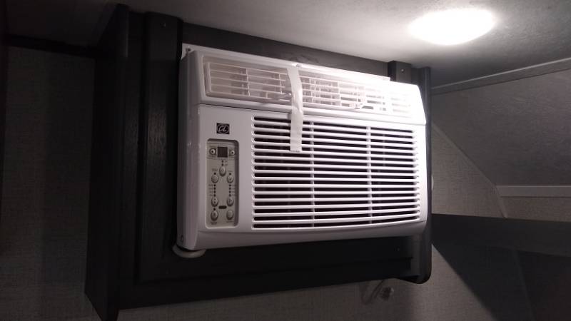Window air conditioner installed in teardrop camper