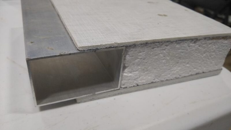 Wall cutaway showing aluminum tubing and EPS foam core