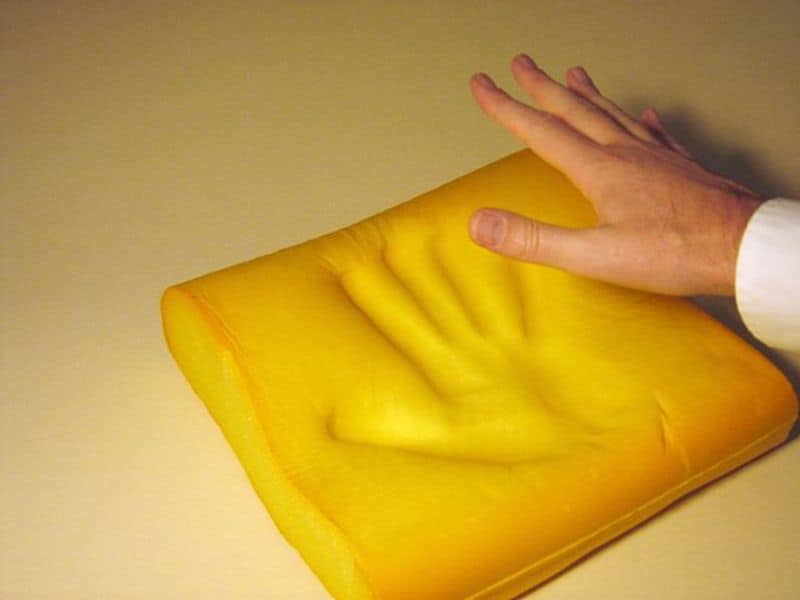 Illustrating showing the imprint of a hand in memory foam.