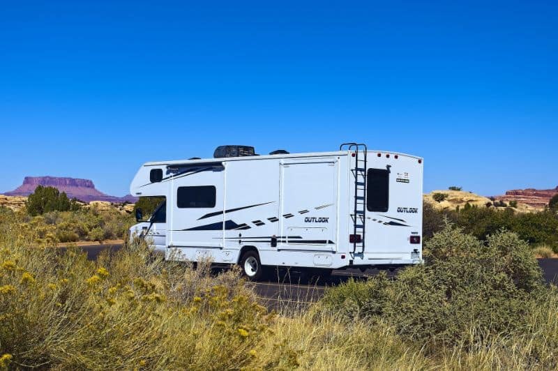 A Class C RV driving in the desert southwest