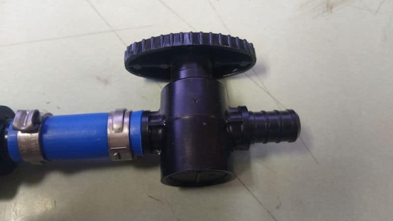 Blue PEX tubing with stainless steel ear crimp ring and plastic barb fitting