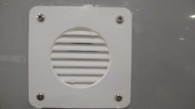 Battery vented box louvers on sidewall of RV