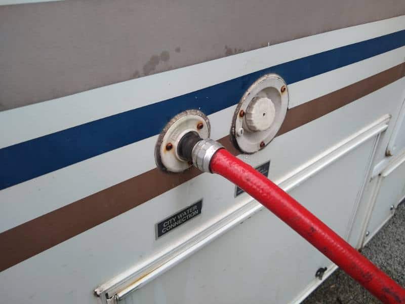 RV city water hose inlet connected to sidewall