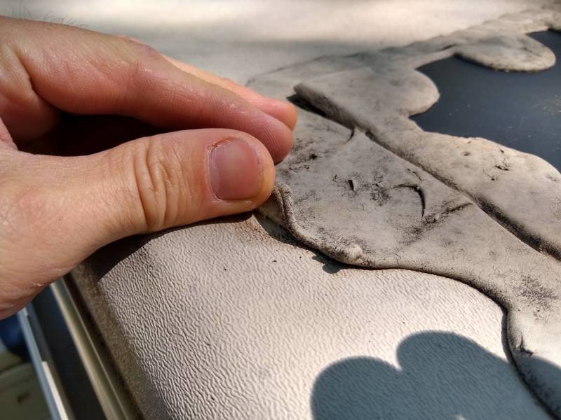 Peeling sealant on RV roof.