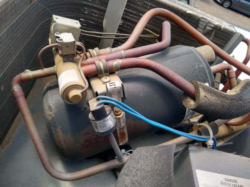 RV air conditioner compressor with PTCR and valve attached.